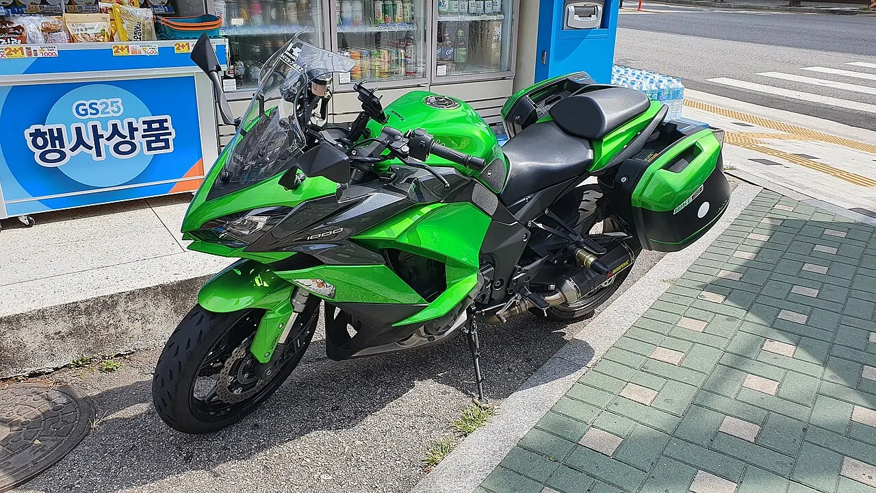 Green Kawasaki Z1000SX sports tourer in a city street