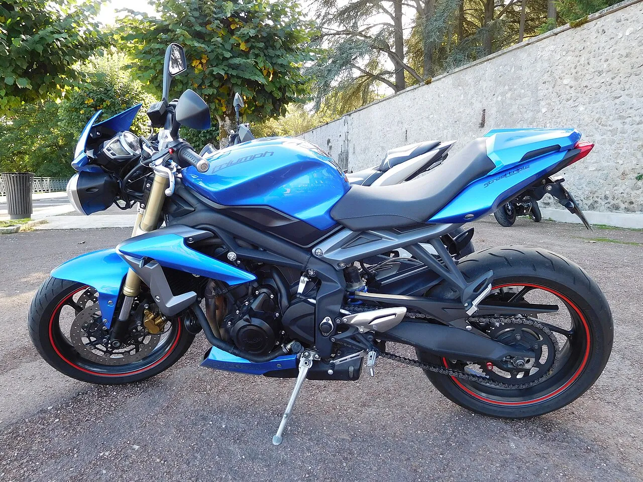 Blue Triumph Street Triple 675 naked motorcycle with a small flyscreen, parked side-on