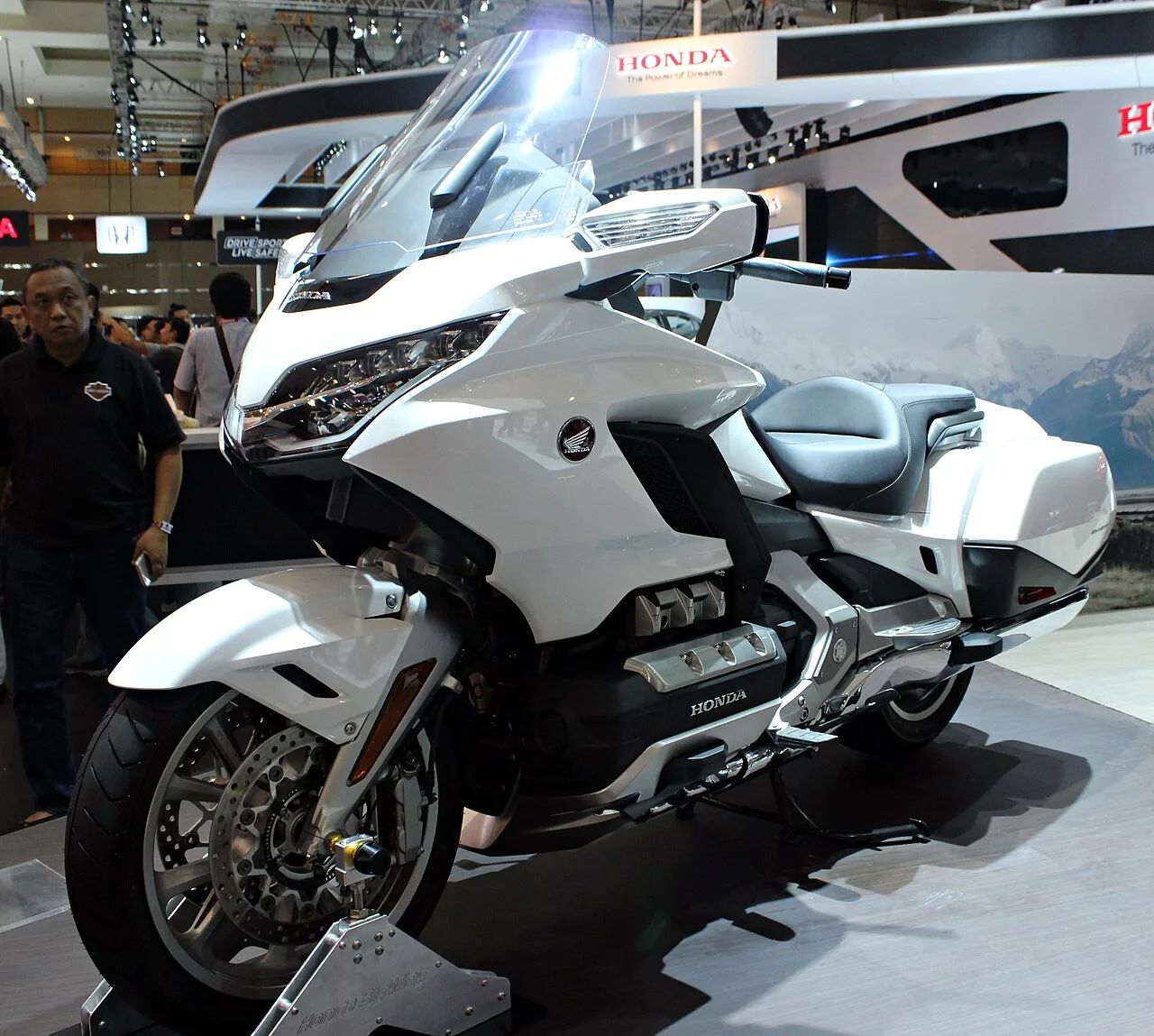 Modern Honda Gold Wing with integrated luggage displayed at a motorcycle show