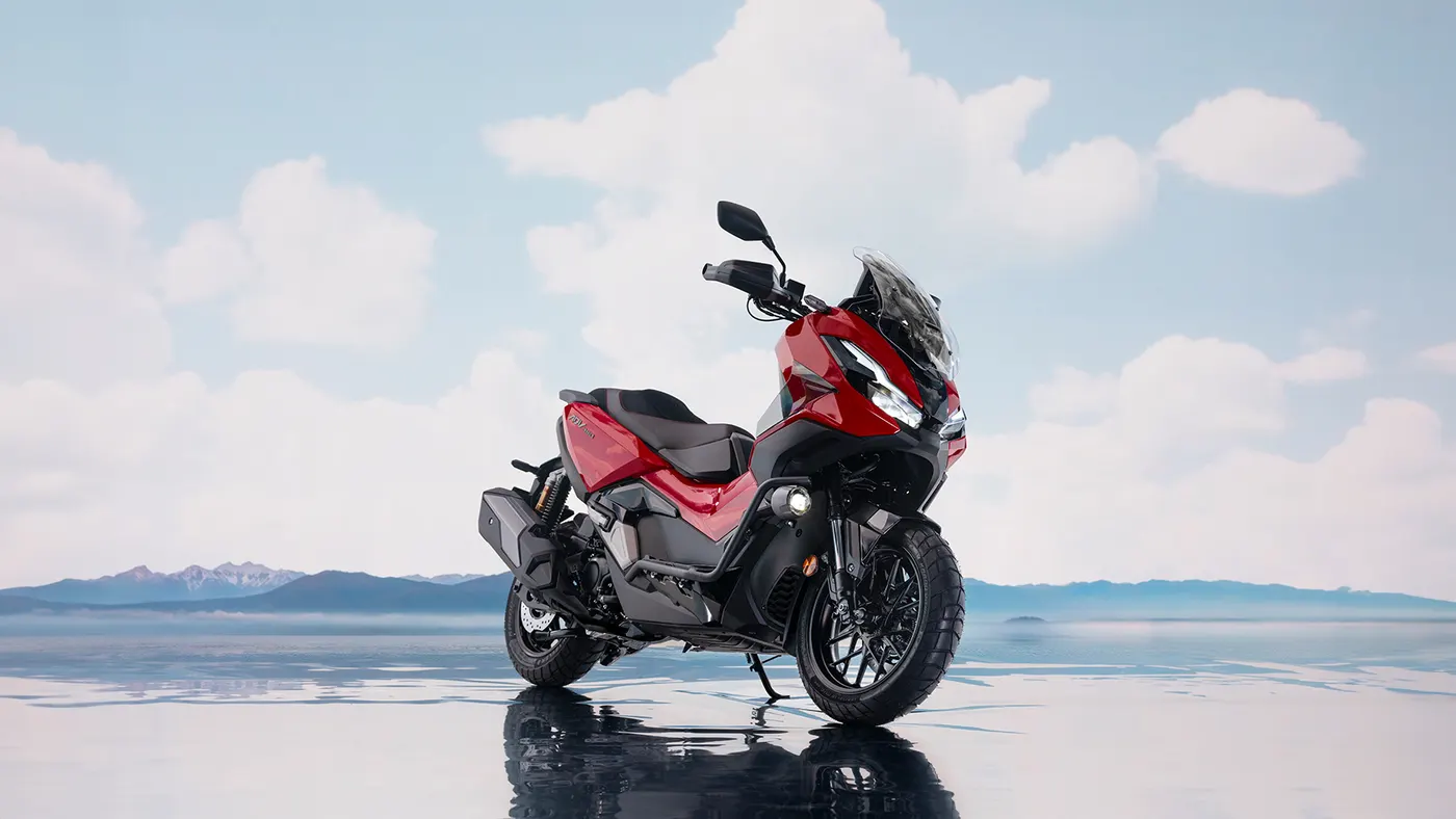 Red Honda ADV350 three-quarter product shot outdoors
