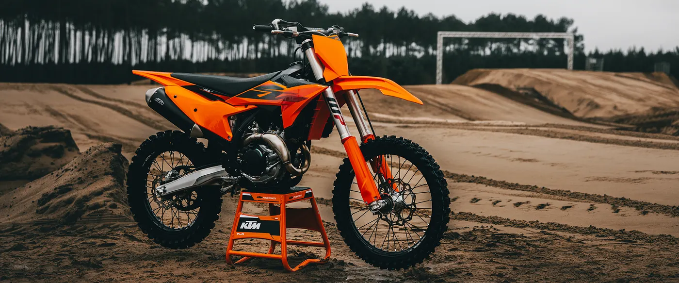 KTM 450 SX-F on a stand at a motocross track