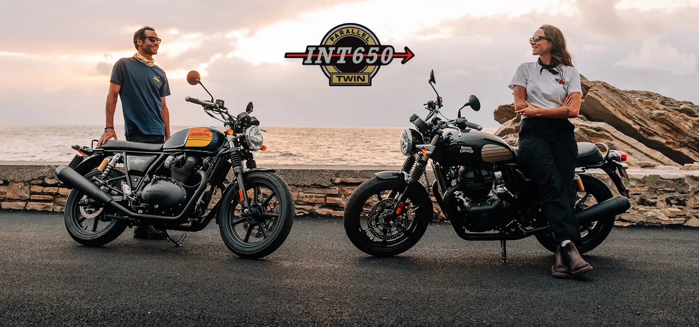 Two Royal Enfield INT 650 motorcycles by the coast