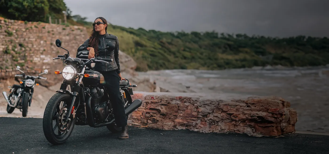 Royal Enfield INT 650 with a rider on a coastal road