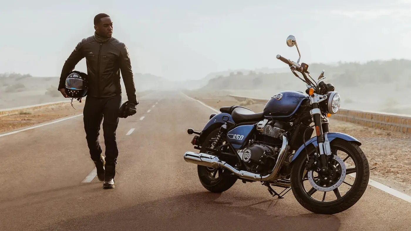 Royal Enfield Super Meteor 650 parked on a wide road with a rider