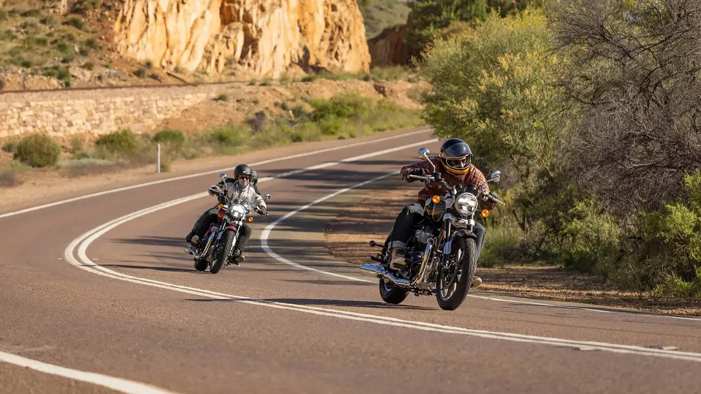 Two Royal Enfield Super Meteor 650 motorcycles cornering on a road