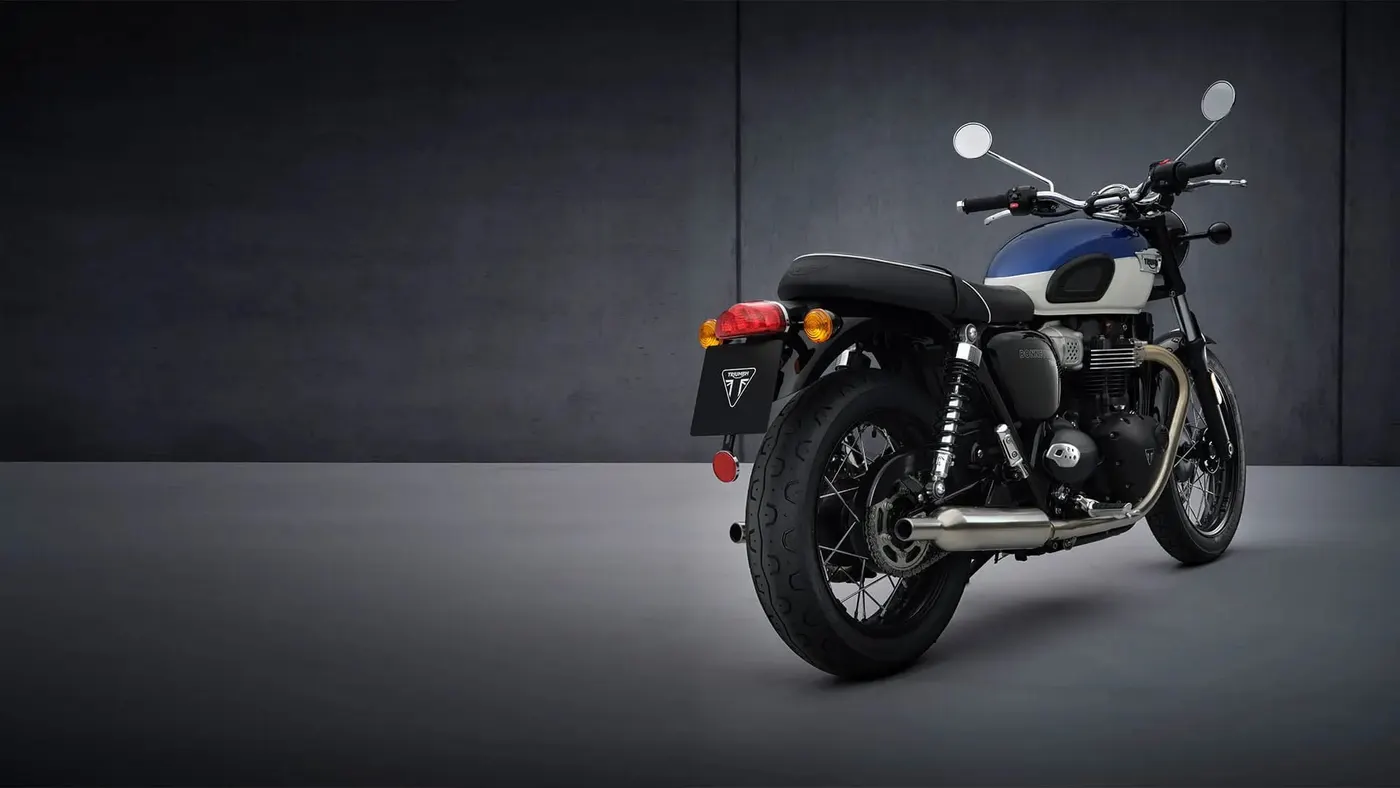 Blue and white Triumph Bonneville T100 studio three-quarter view