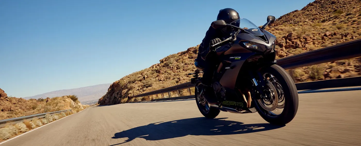 Triumph Daytona 660 ridden on a mountain road, front three-quarter view