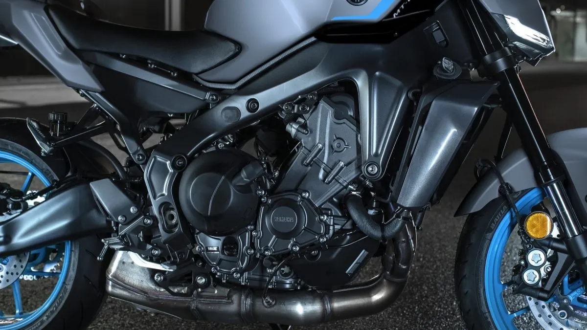 Close-up of the Yamaha MT-09 engine, frame, fork and blue wheel