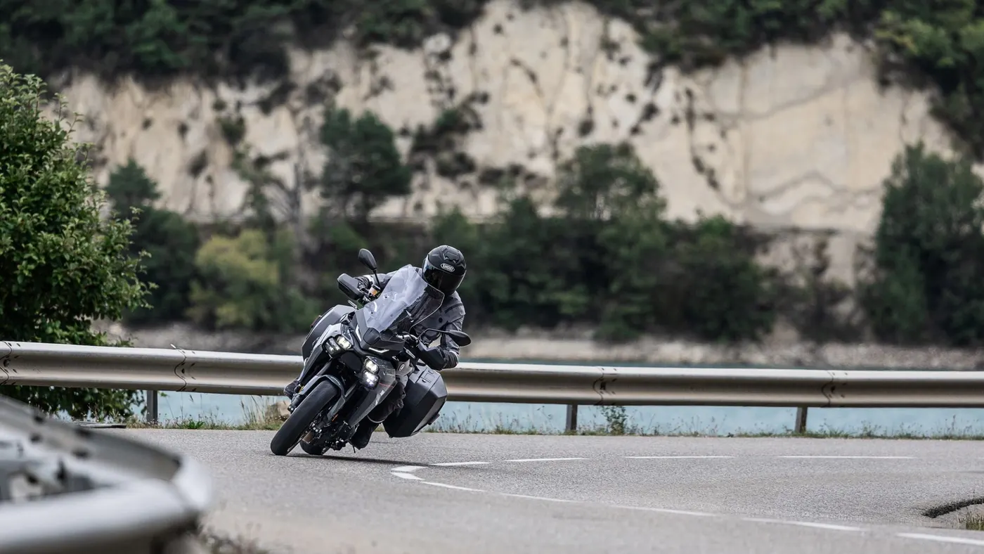 Yamaha Tracer 9 with luggage ridden through a sweeping mountain bend