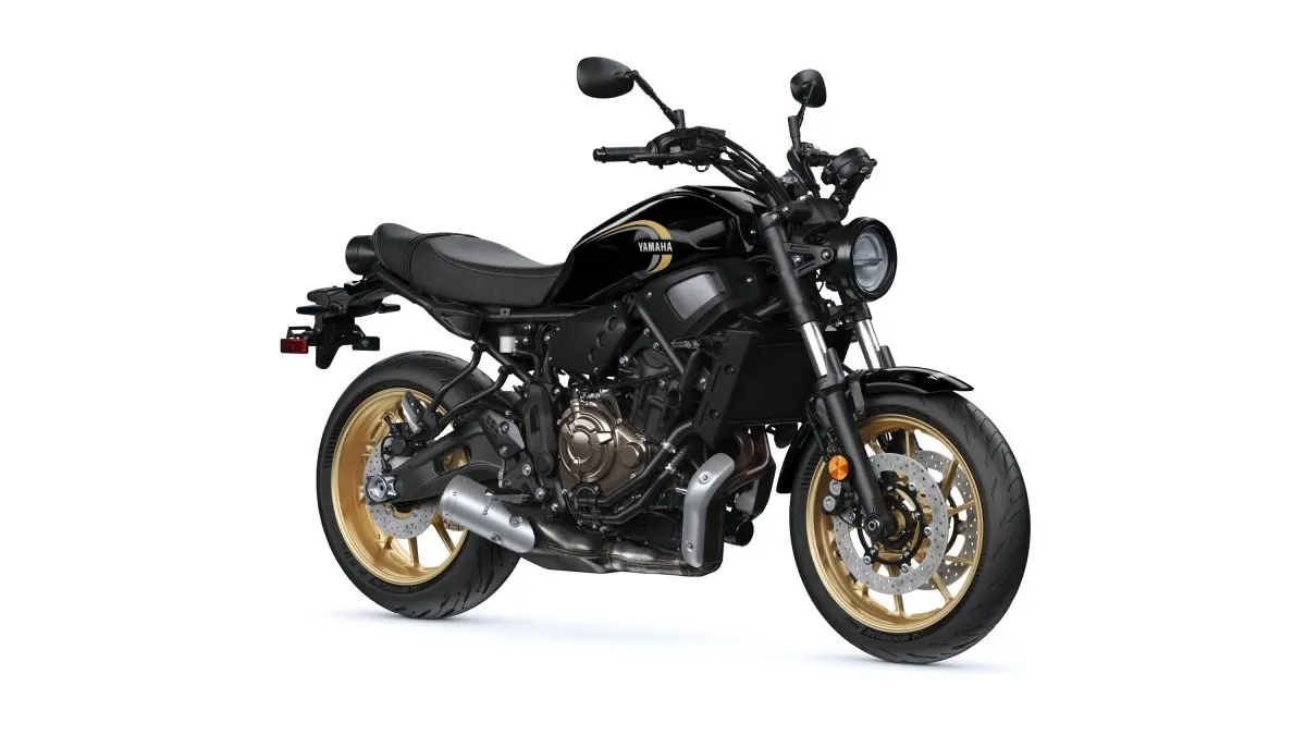 Black Yamaha XSR700 with gold wheels, right front three-quarter studio view