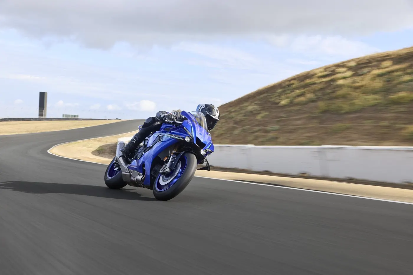 Blue Yamaha YZF-R1 cornering hard on a race track